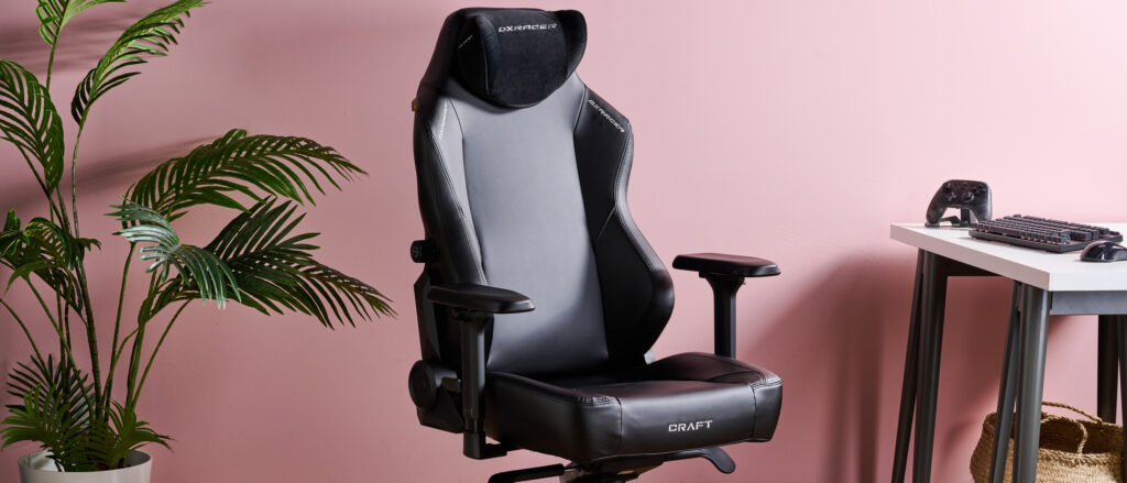 DXRacer Craft with plant, desk, and pink wall in background