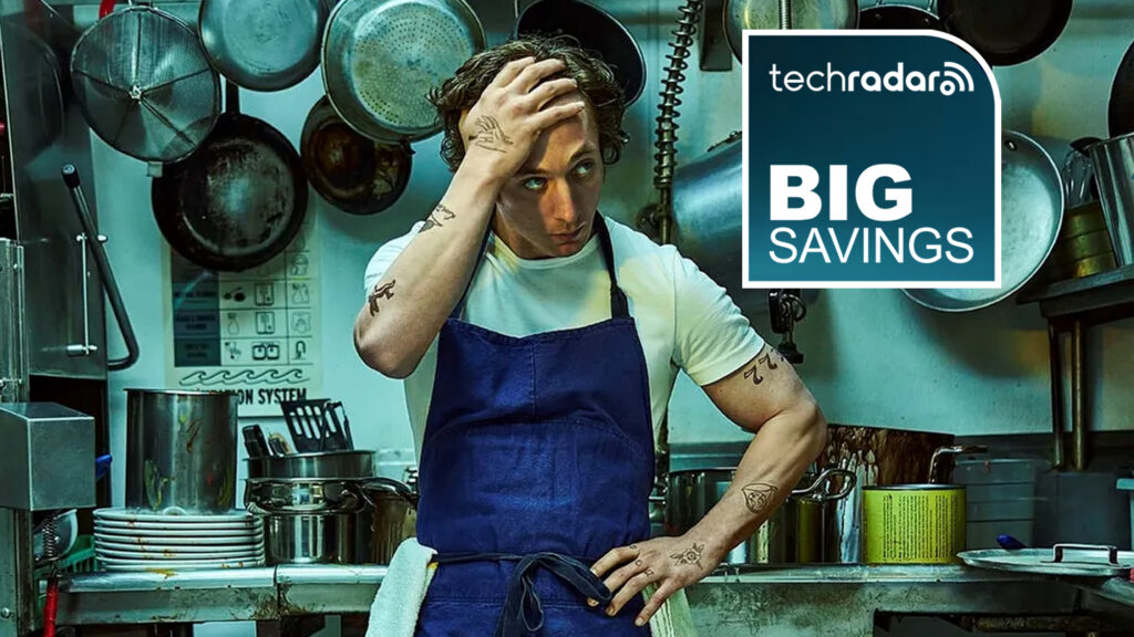 Carmy from The Bear looking stressed in a kitchen, with a deals logo stating 'big savings' next to him.
