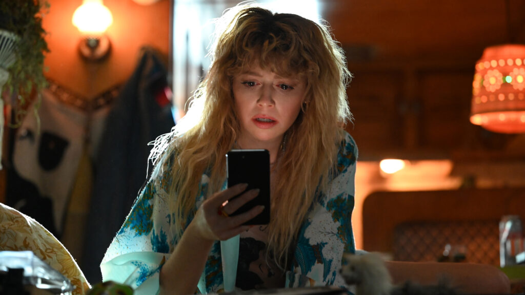 Get a year of Peacock for just $2 per month, just in time for Poker Face season 2 with 100% on Rotten Tomatoes Charlie Cale looks concerned as she looks at her phone in Poker Face