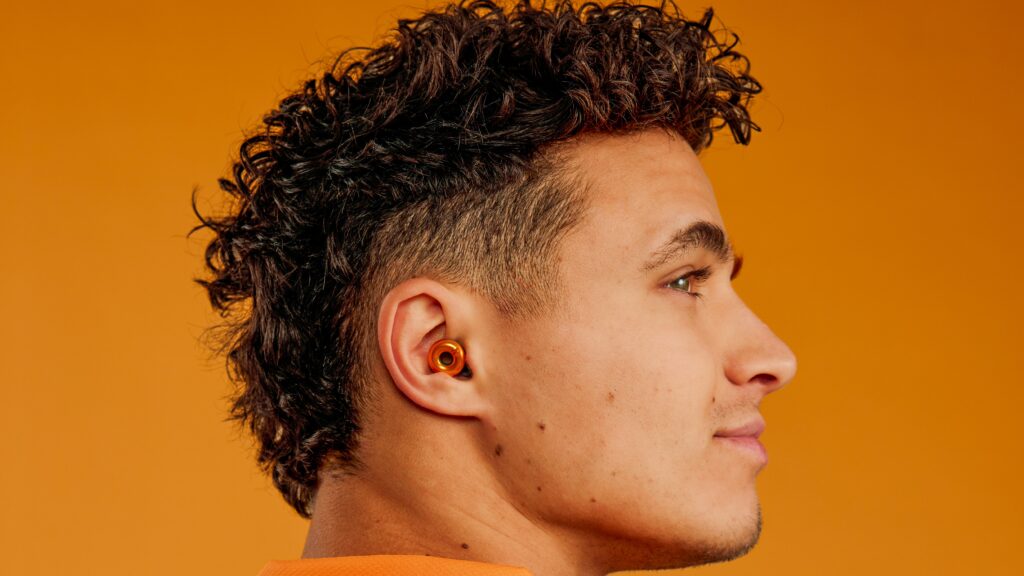 A McLaren driver wearing the McLaren orange Loop Switch 2