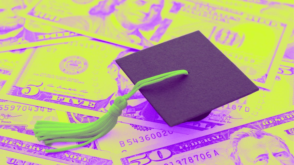 a graduation cap sits on top of a pile of dollar bills