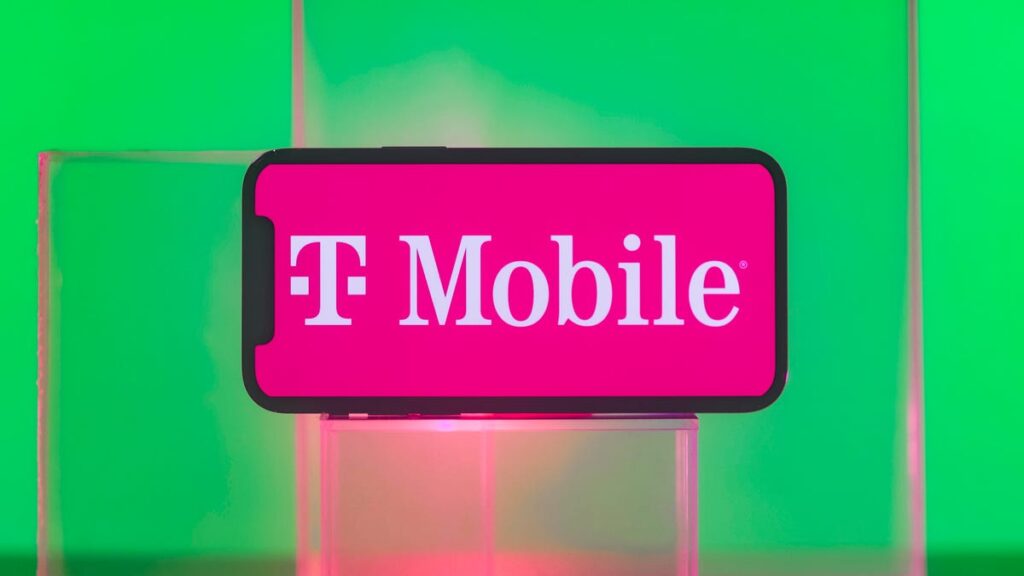 T-Mobile logo on a mobile phone against a green background.