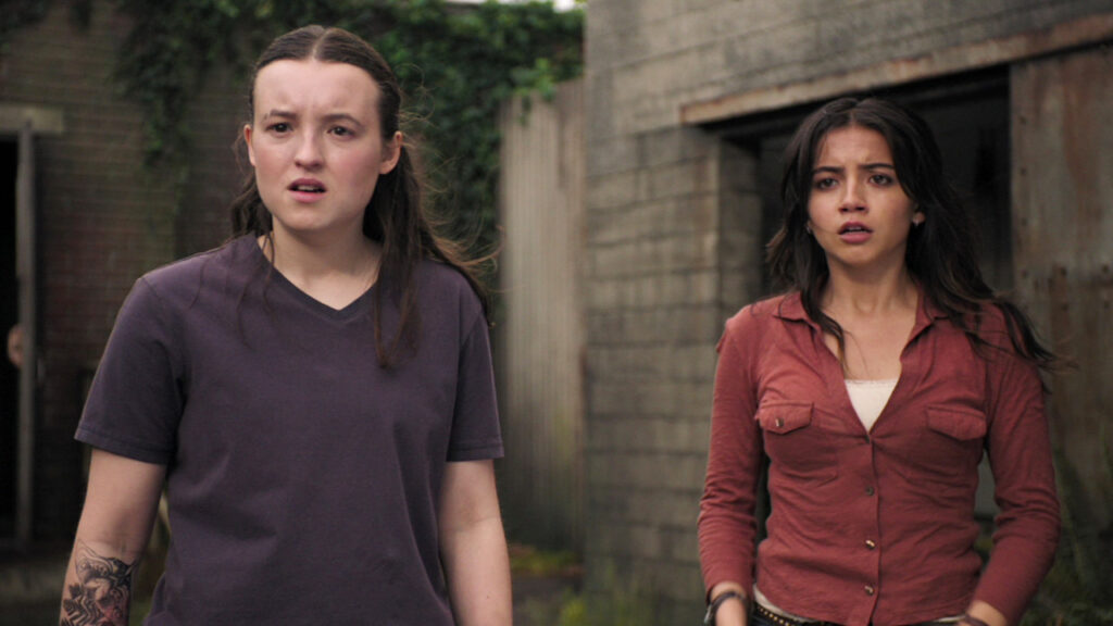 Ellie and Dina standing and looking shocked in The Last of Us season 2 episode 4
