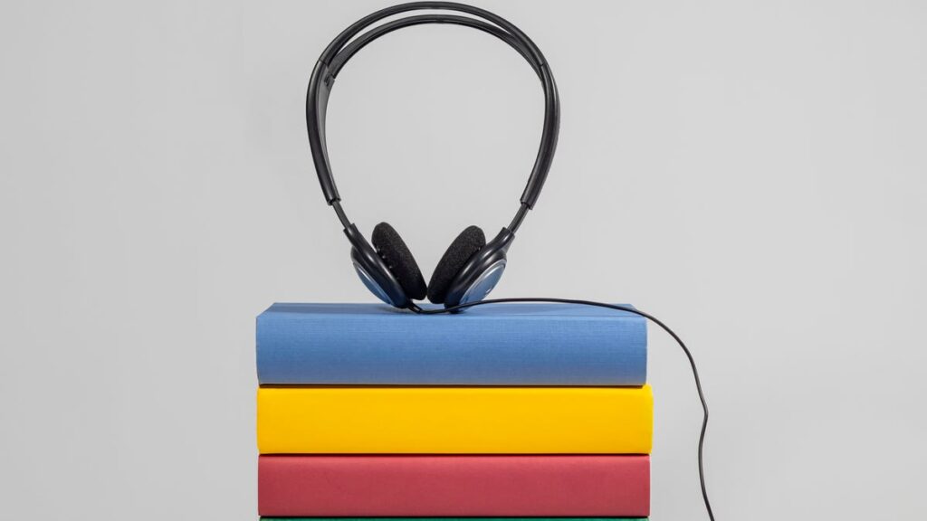 Stack of books with headphones on top.