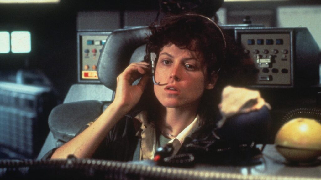 Sigourney Weaver sits on a headset aboard the Nostromo in Alien