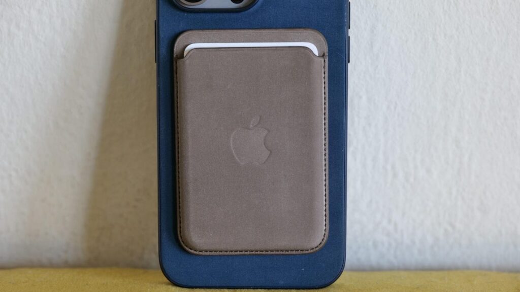 An iPhone 15 Pro Max with FineWoven case and wallet