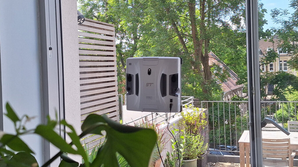Hobot S7 Pro window cleaning robot on inside of reviewer's patio door window