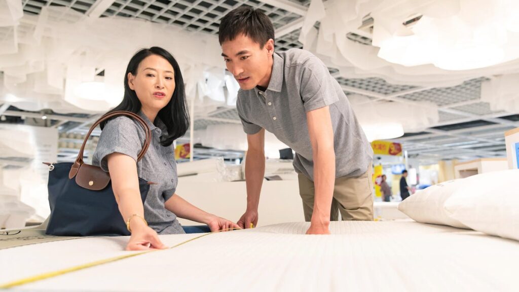 Couple shopping for a mattress.