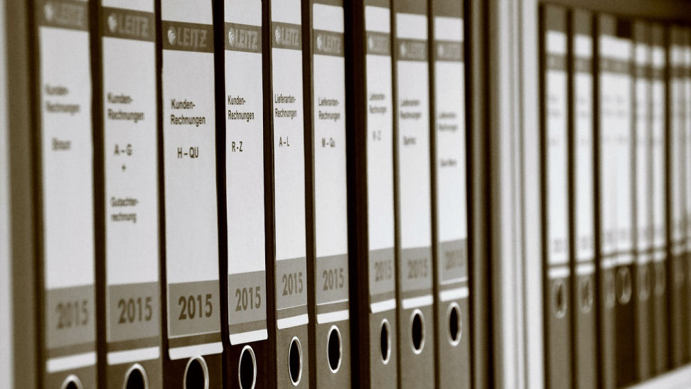 Compliance relics: the case against PDFs and screenshots A shelf filled with folder files