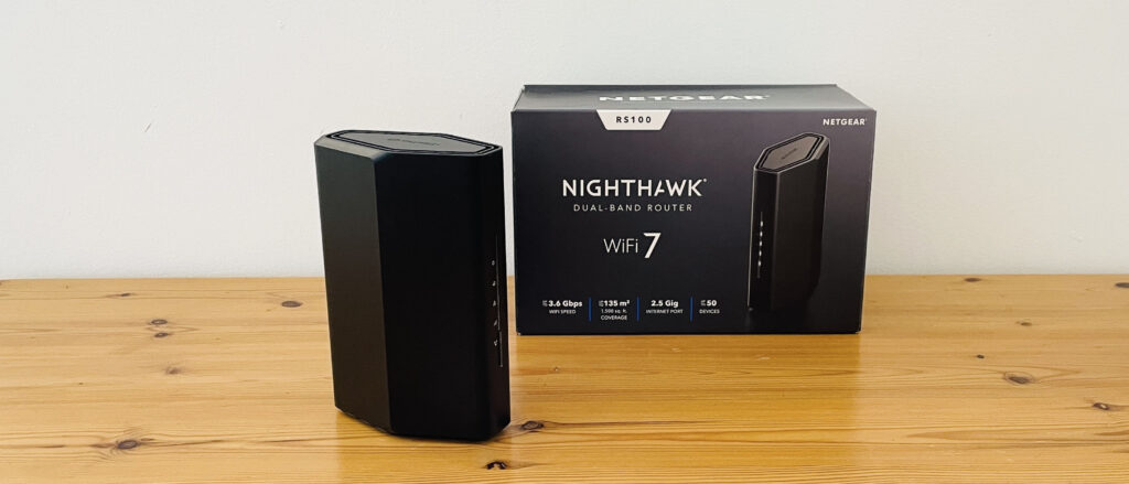 Netgear Nighthawk RS100 router on wooden table