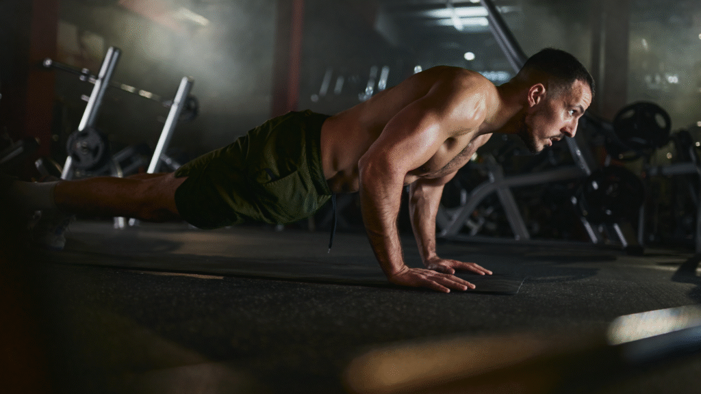 A man performing a push up in the gym