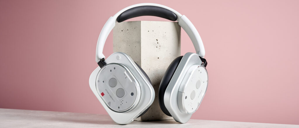 The Nothing Headphone (1) standing up against a pink wall