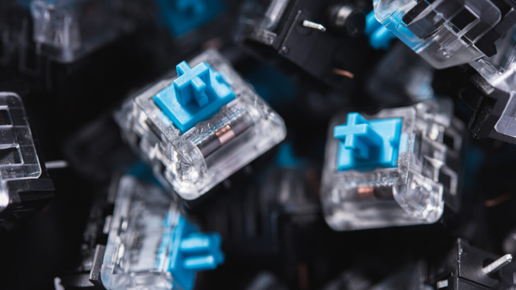 How to choose which keyboard switch is right for you: from durability to performance Macro photo of blue mechanical keyboard switches