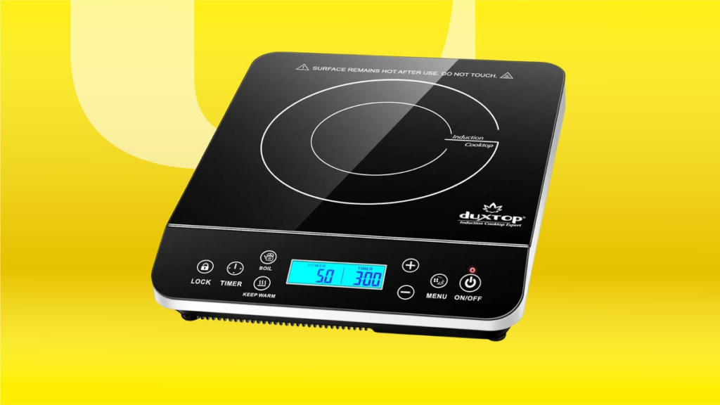 This Portable Induction Cooktop Is the Hero That Got Me Through a Kitchen Remodel A square, black electronic cooktop, set against a bright yellow background.