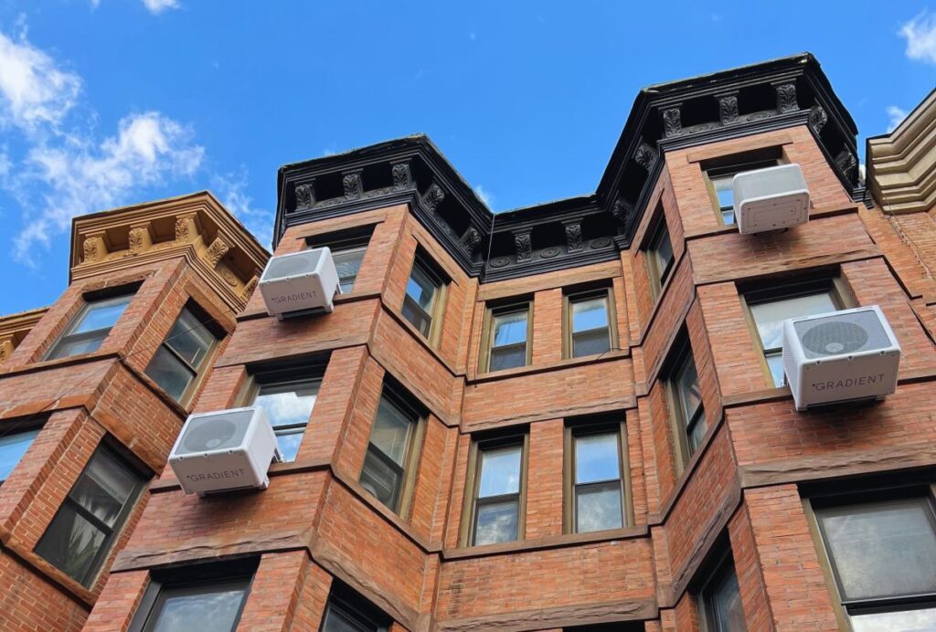 Gradient’s heat pumps get new smarts to enable old-building retrofits Heat pumps hang on the outside of an apartment building.