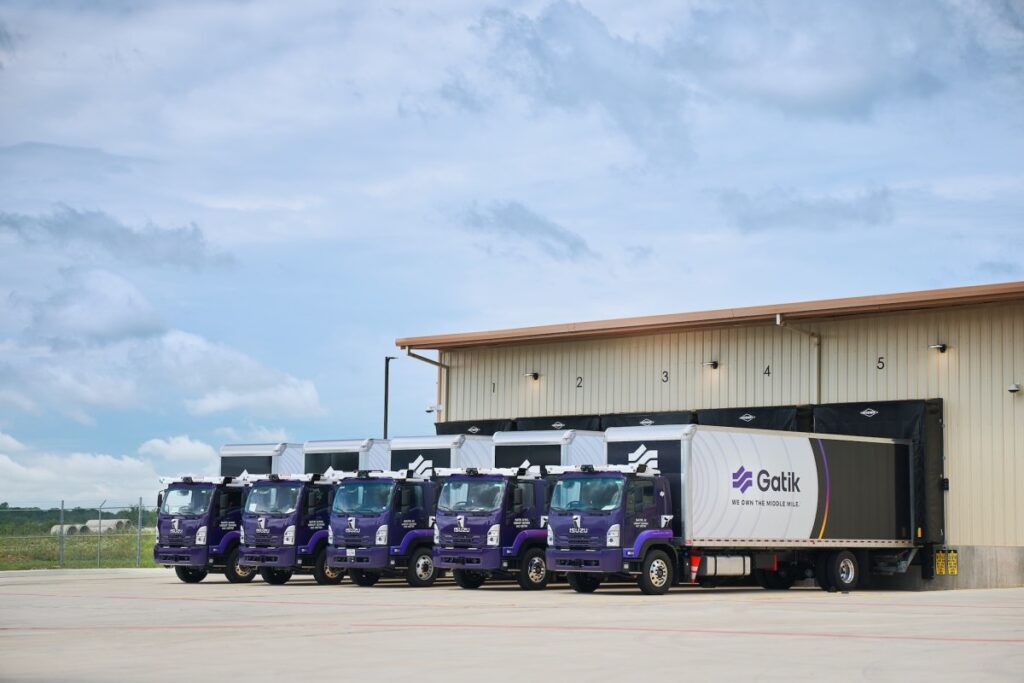 Gatik trucks backed up to loading bays