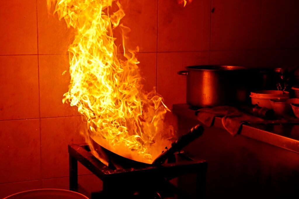 A fire rages in a kitchen.